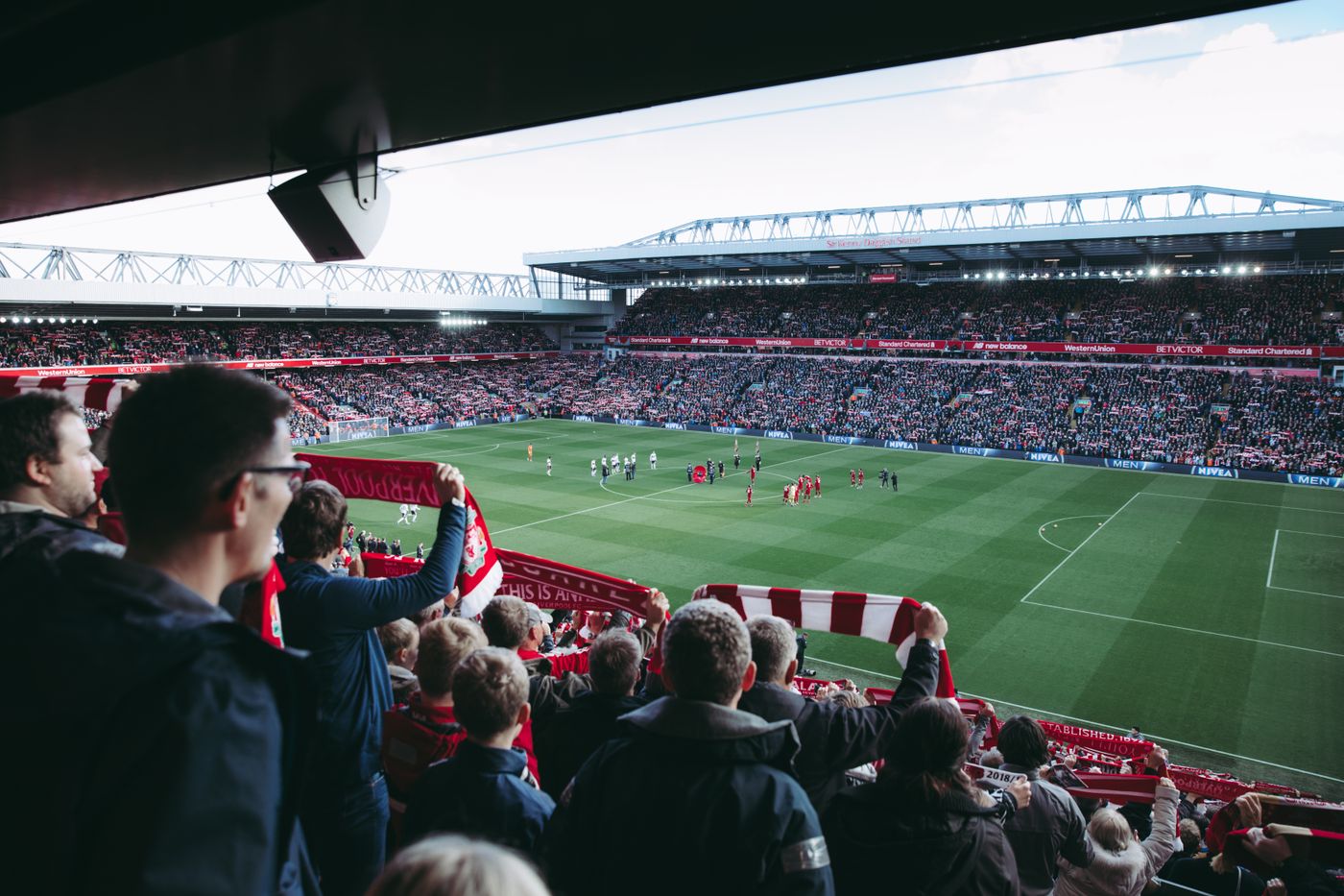 A view of a football pitch from among the crowd in the stands.