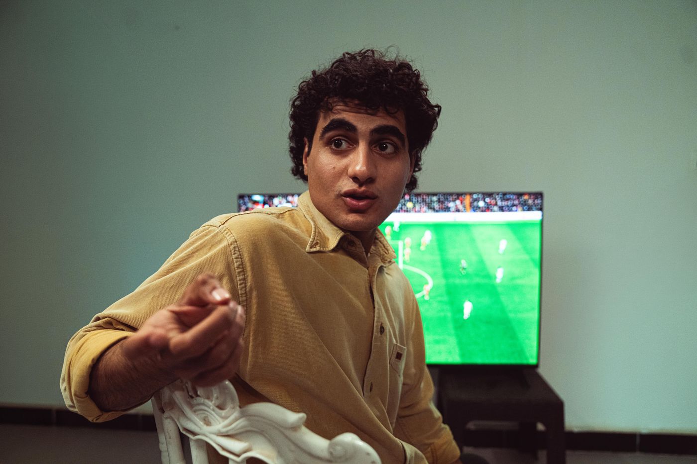 A fan group reacting to a soccer match on television.