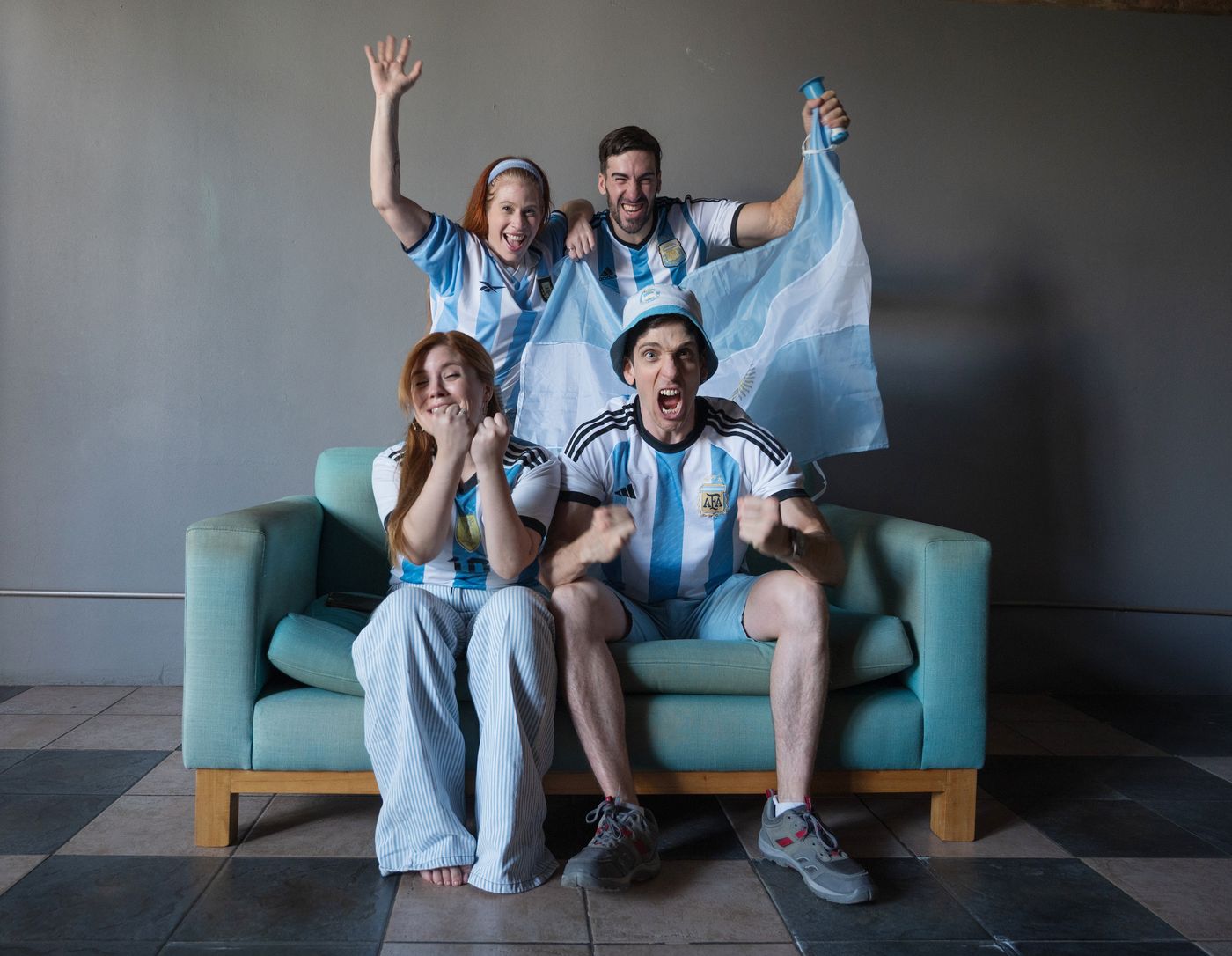 A group of soccer fans reacting to a match together.
