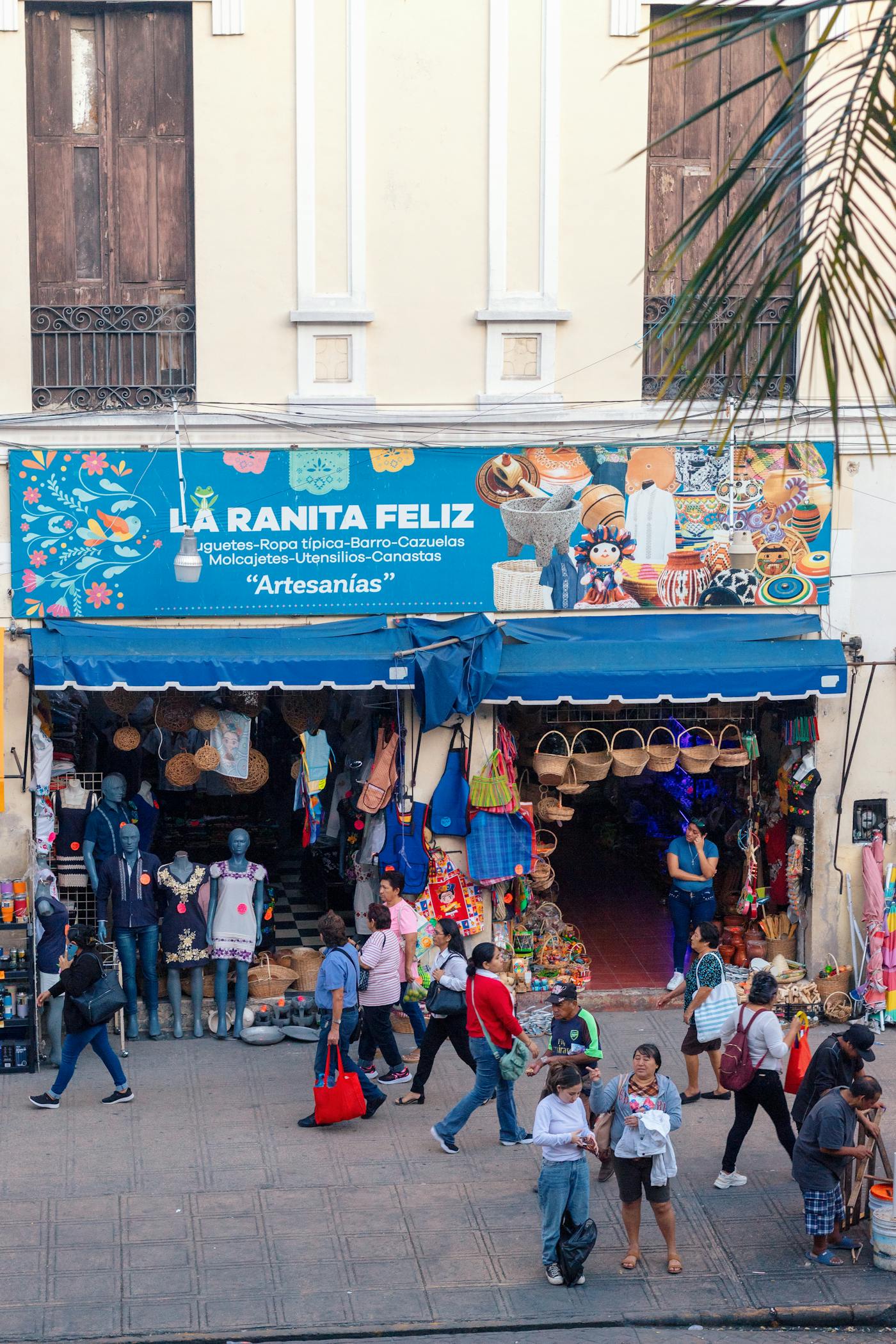 People walking through a busy street market in Mexico City.