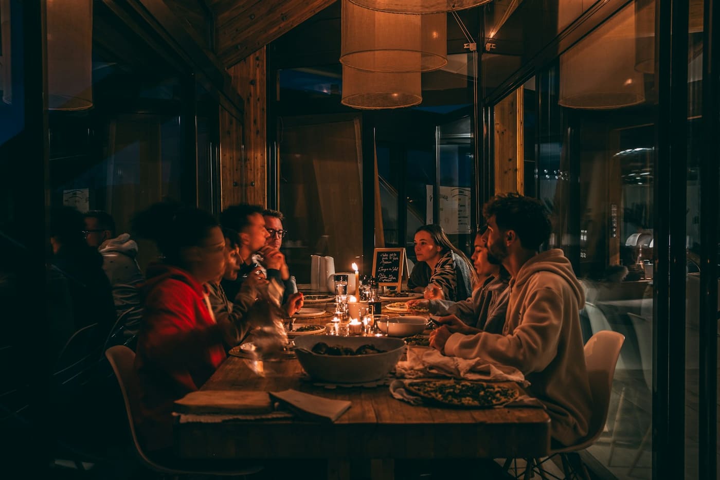 A candlelit dinner table at a dimly lit restaurant.