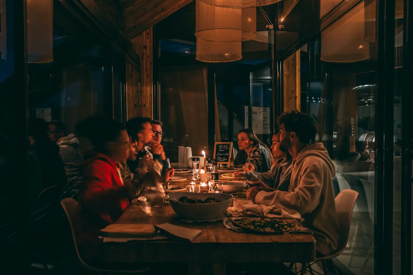 A candlelit dinner table at a dimly lit restaurant.