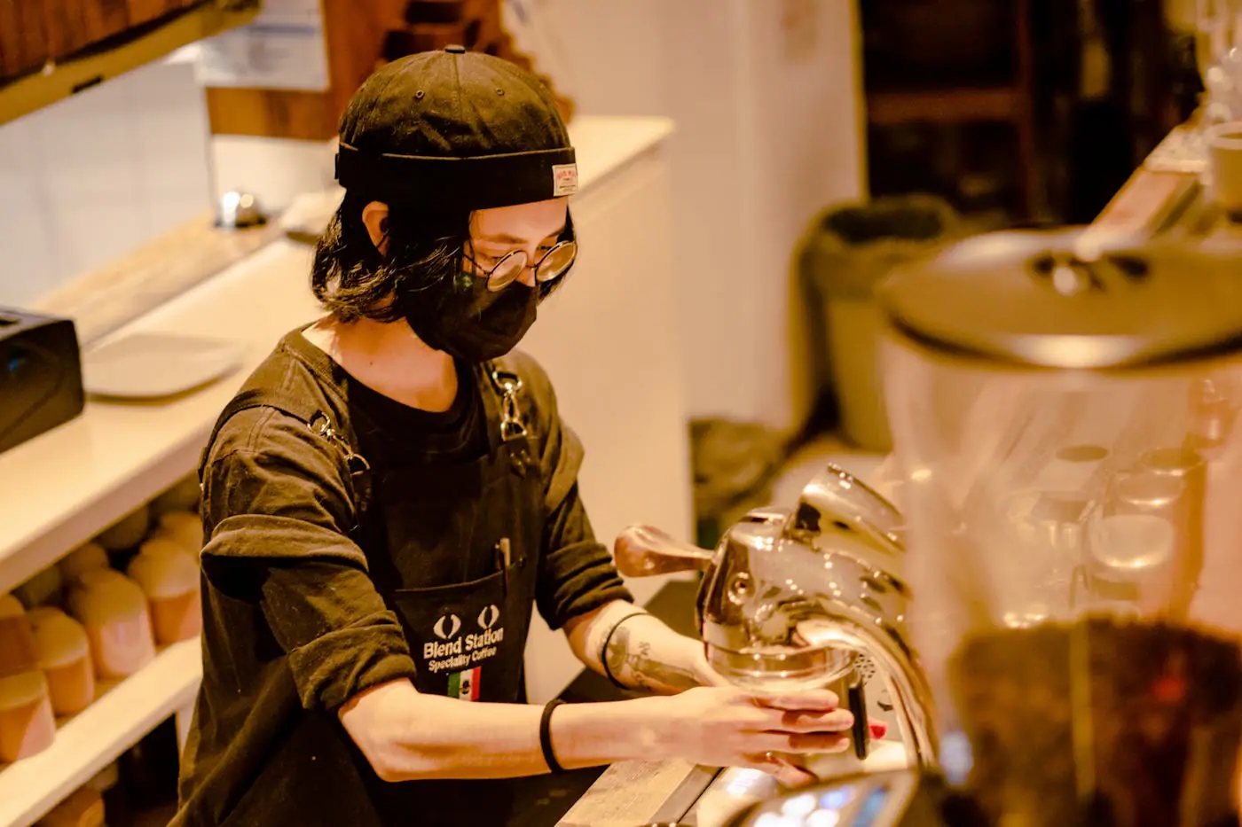 A barista working behind a counter in a Mexico City cafe.