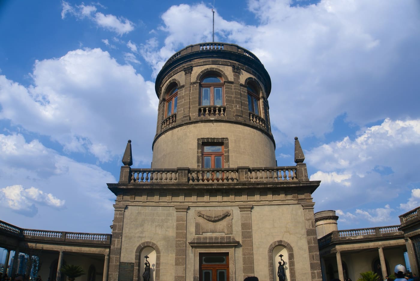 The stone tower of Chapultepec Castle against a blue sky.