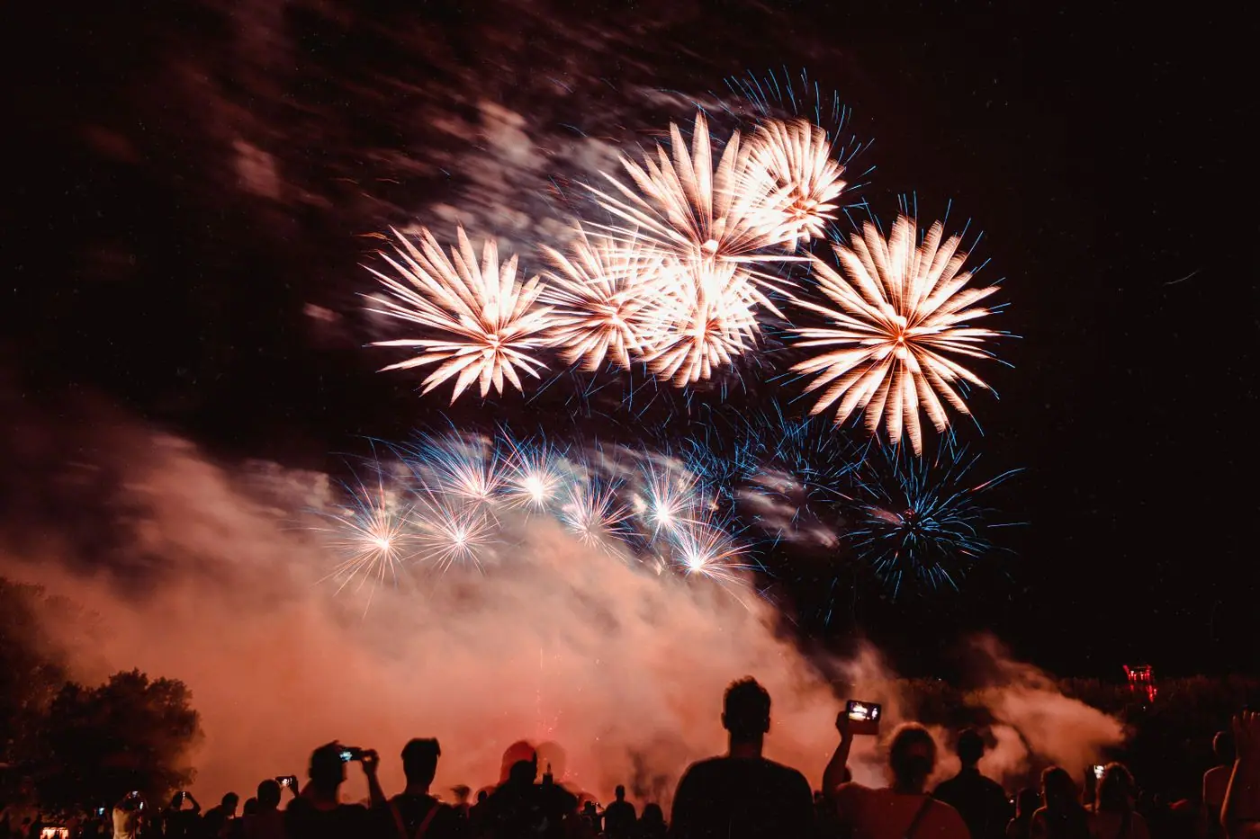 Fireworks exploding over a Mexican plaza right after the El Grito shout ends.