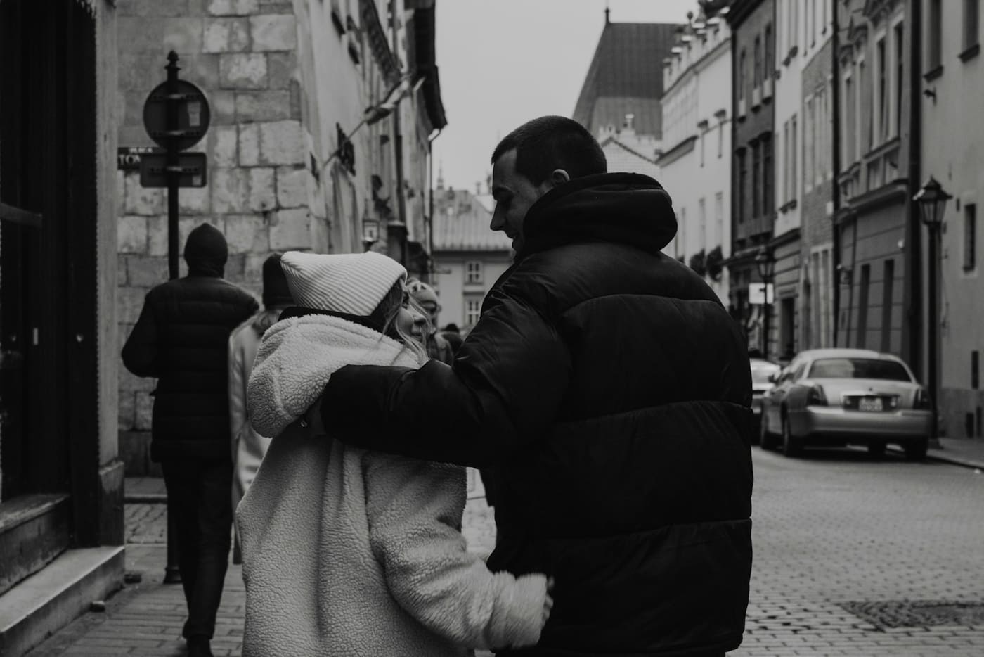 A man and a woman walking together down a city street.