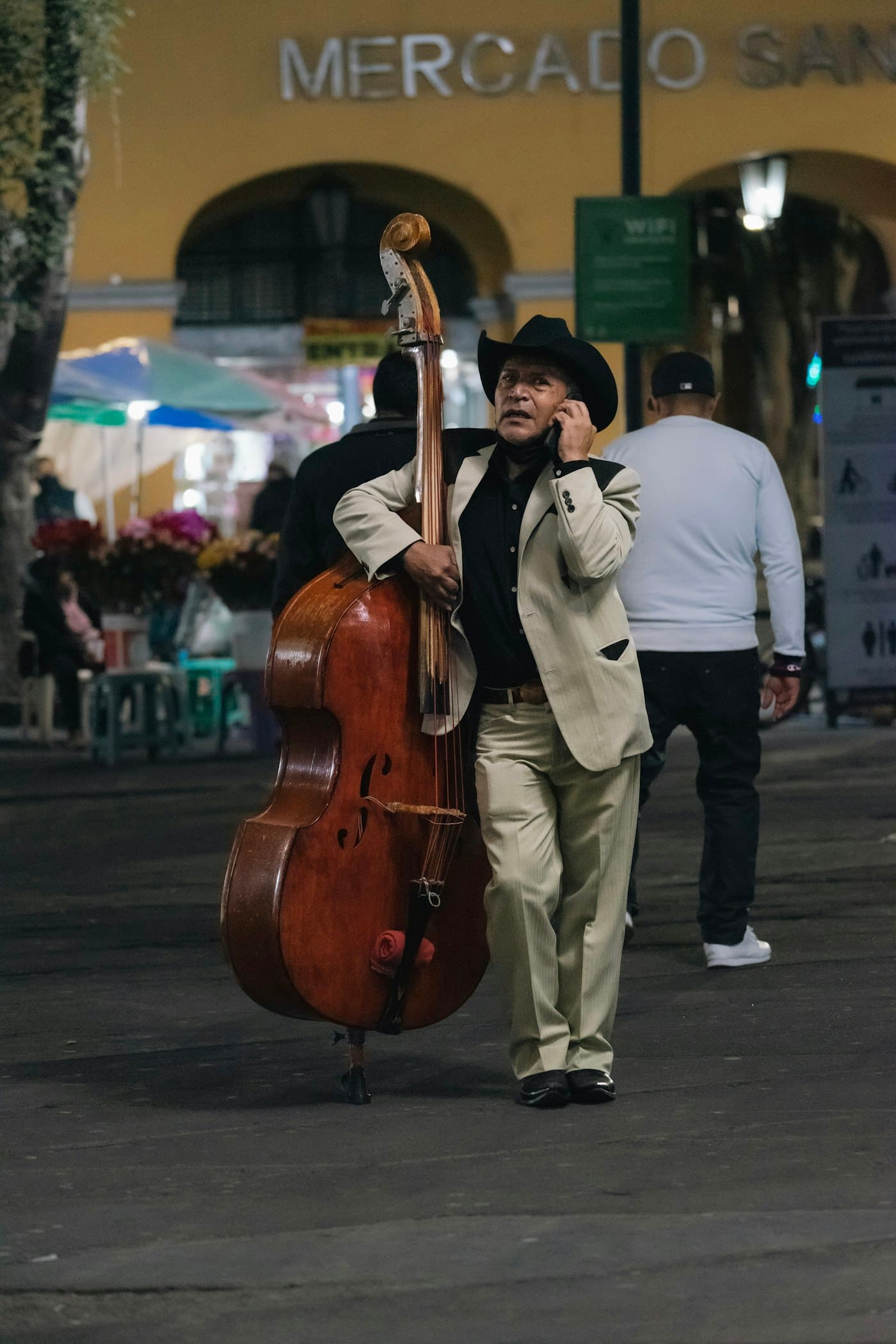 A musician using a phone outside Mercado San Juan in Mexico City.