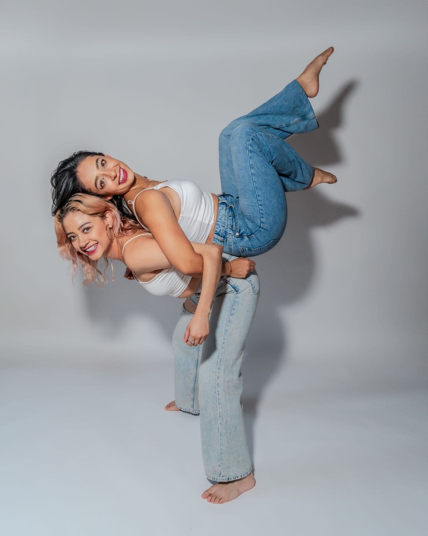 Two young women posing playfully together in Mexico City.