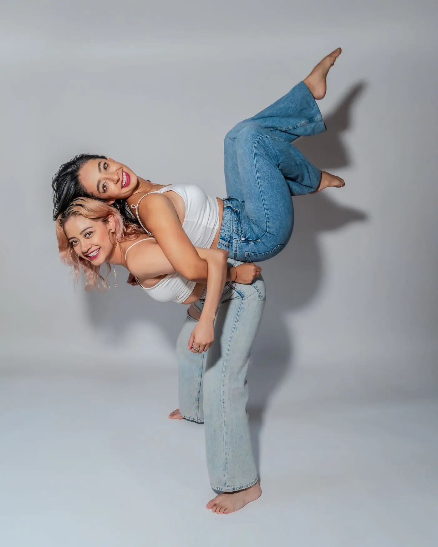 Two young women posing playfully together in Mexico City.