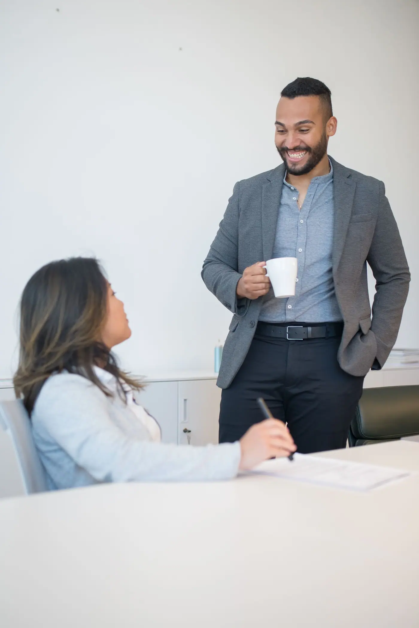 Coworkers talking in an office break area.