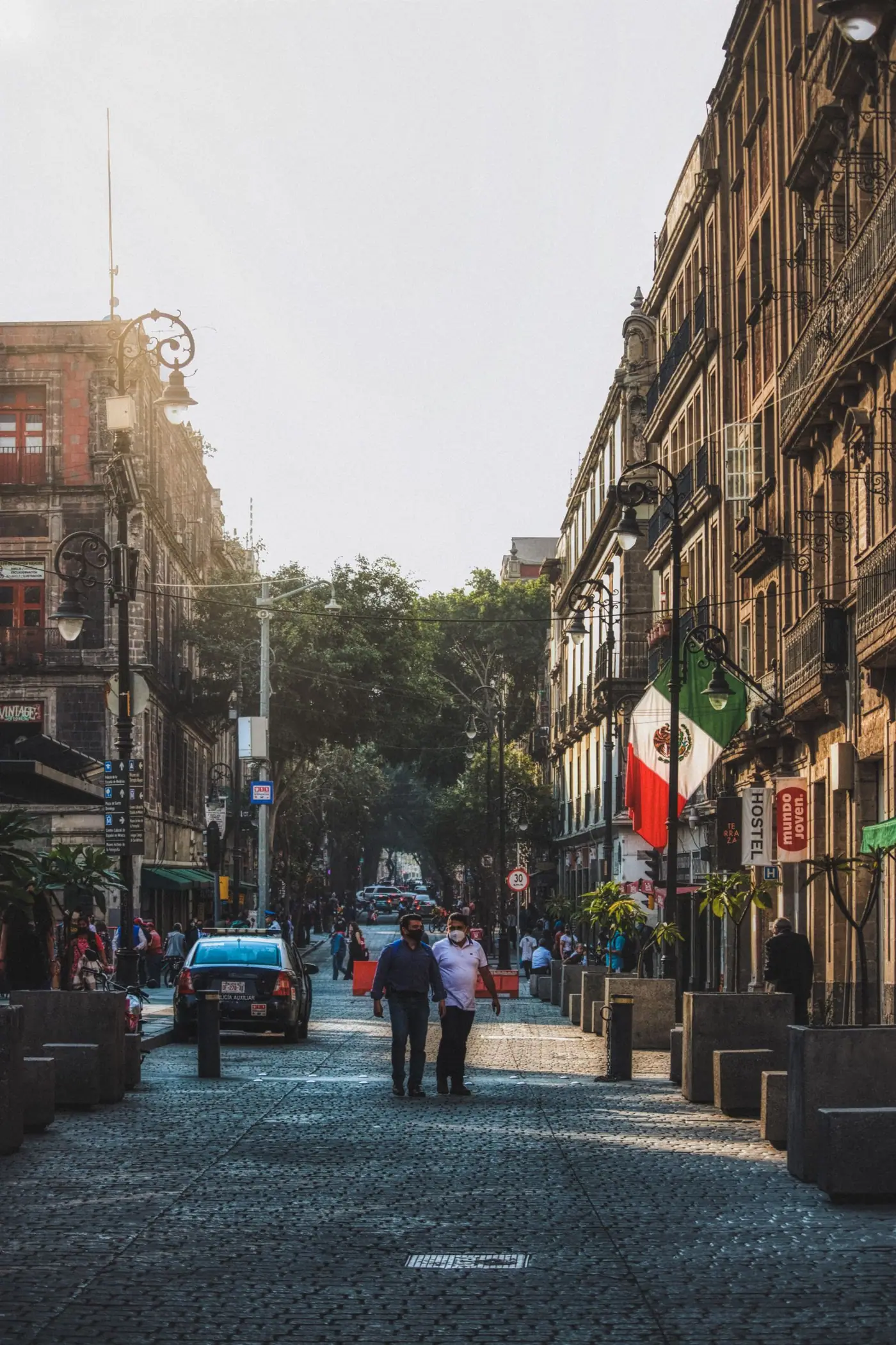 A busy street with historic buildings in central Mexico City.