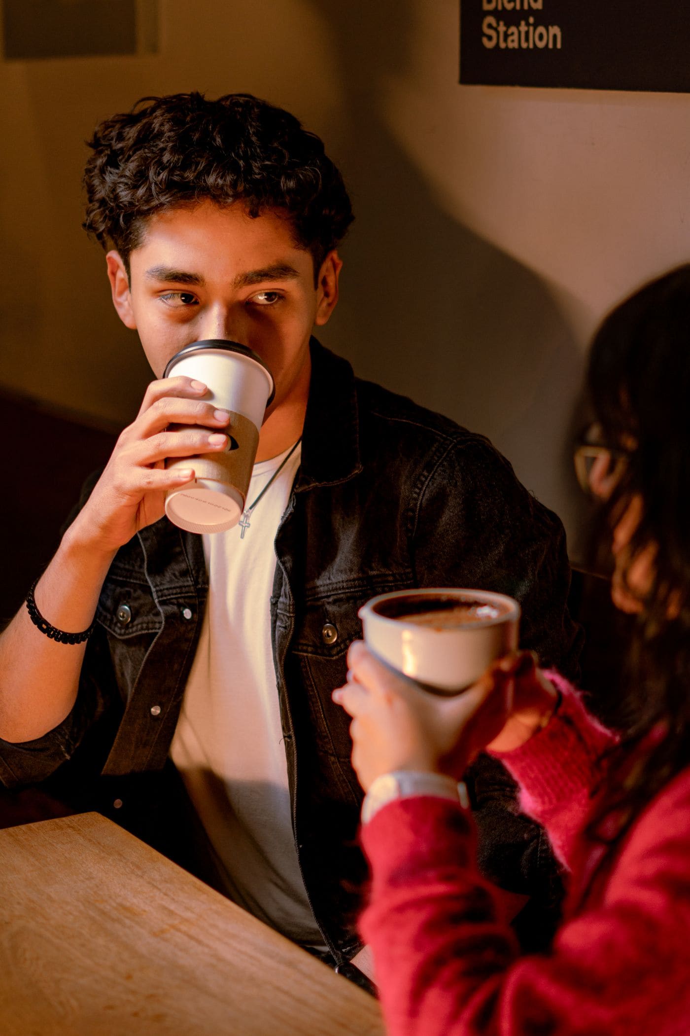 A young couple sharing coffee in a cafe in Mexico City.