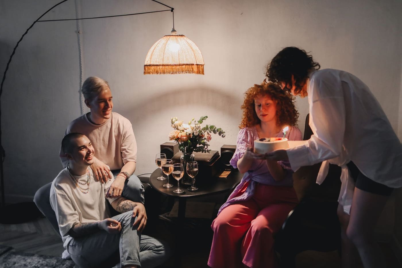 A small group of friends talking at a cozy home celebration.