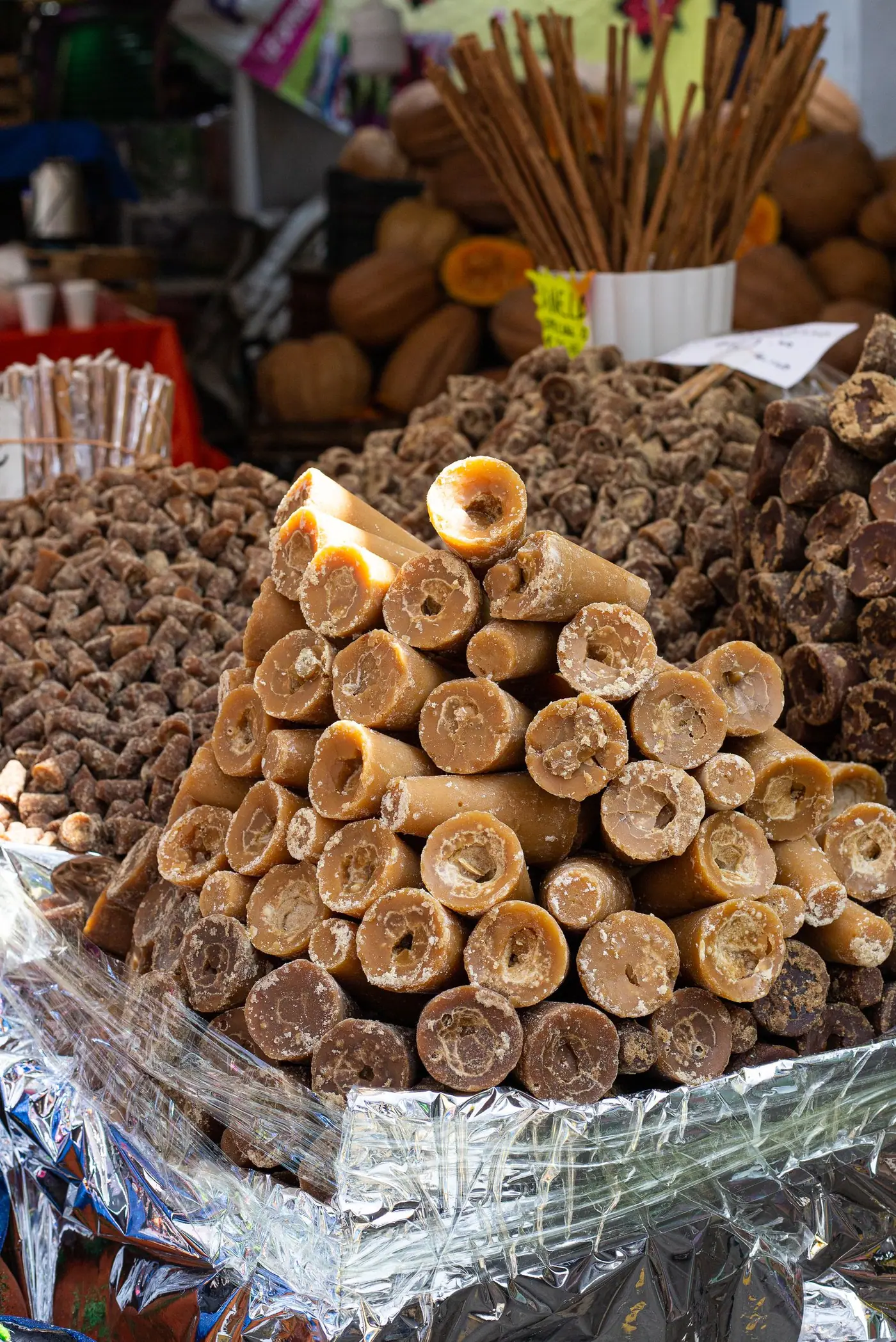 Cones of unrefined brown sugar stacked on a market stall in Mexico.
