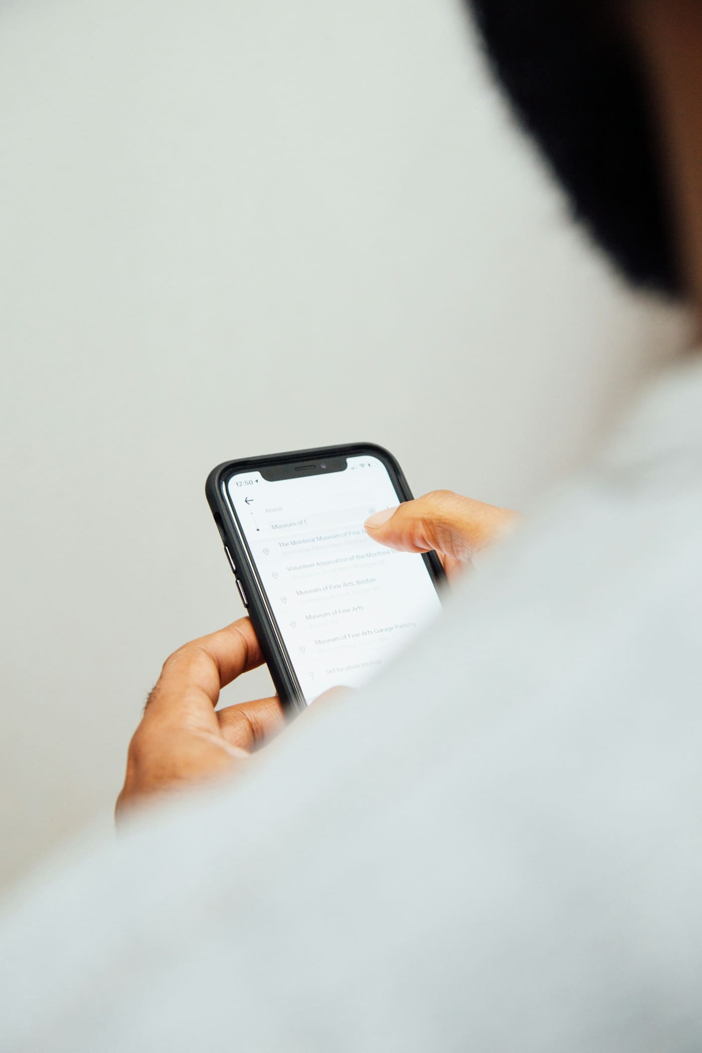A close-up of a person's hands holding a phone and typing a message.