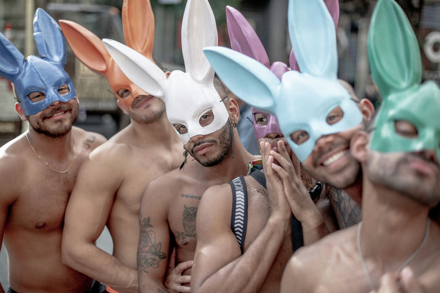 A group of men wearing colorful bunny masks at Pride.