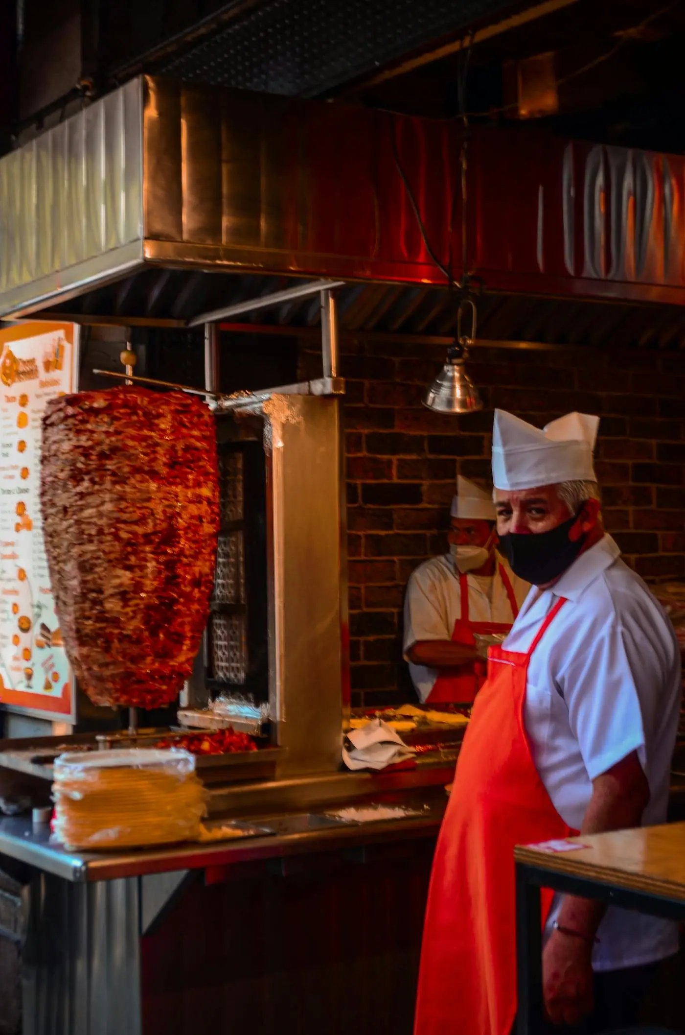 A taquero preparing tacos al pastor in Mexico City.