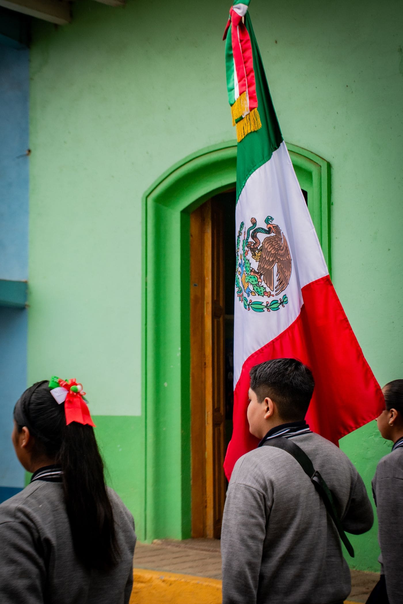 A student holding notebooks and pencils for school.