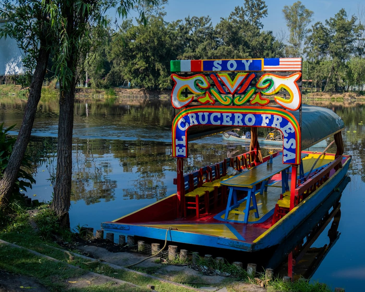 A brightly painted trajinera on the water at Xochimilco.