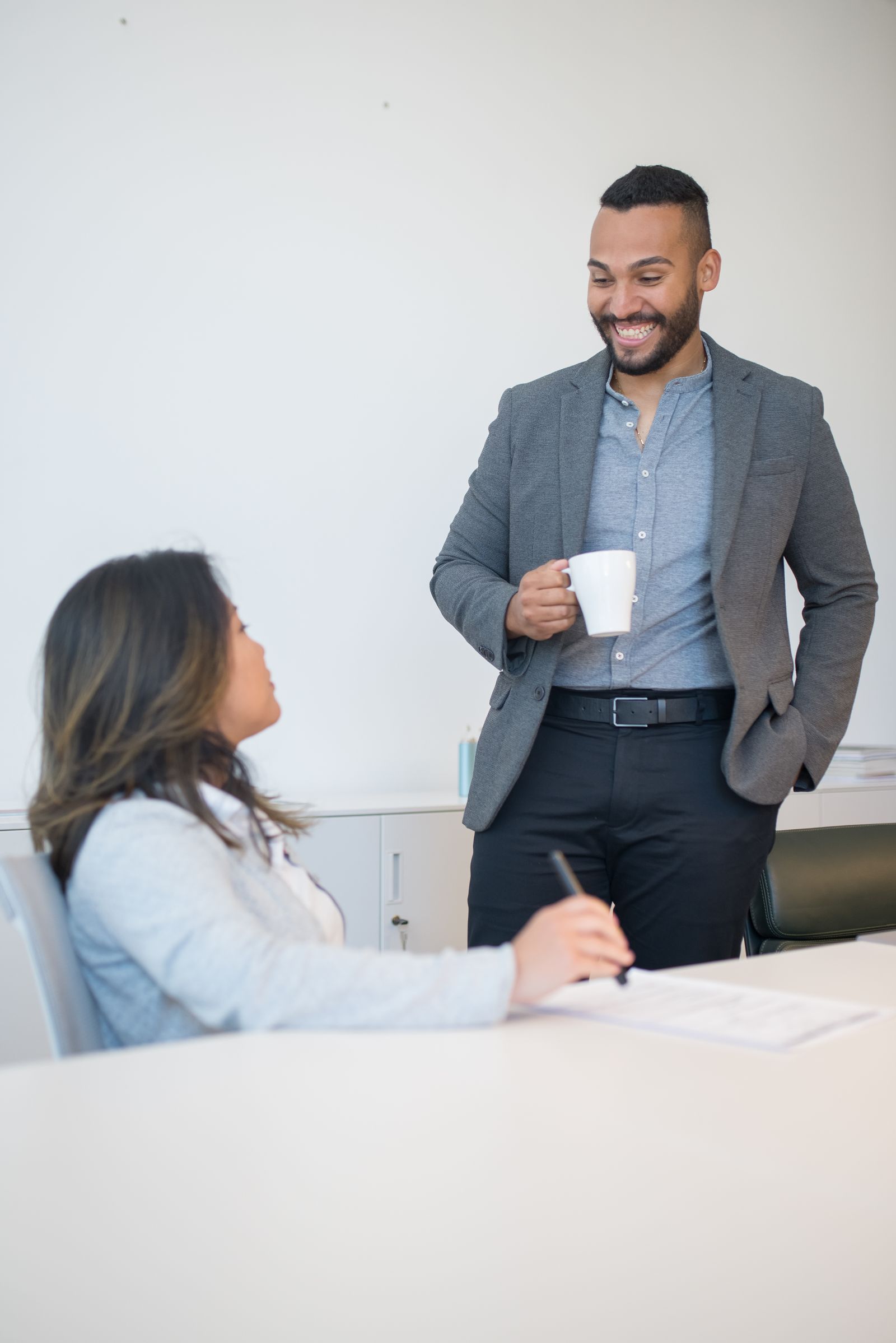Coworkers talking in an office break area.