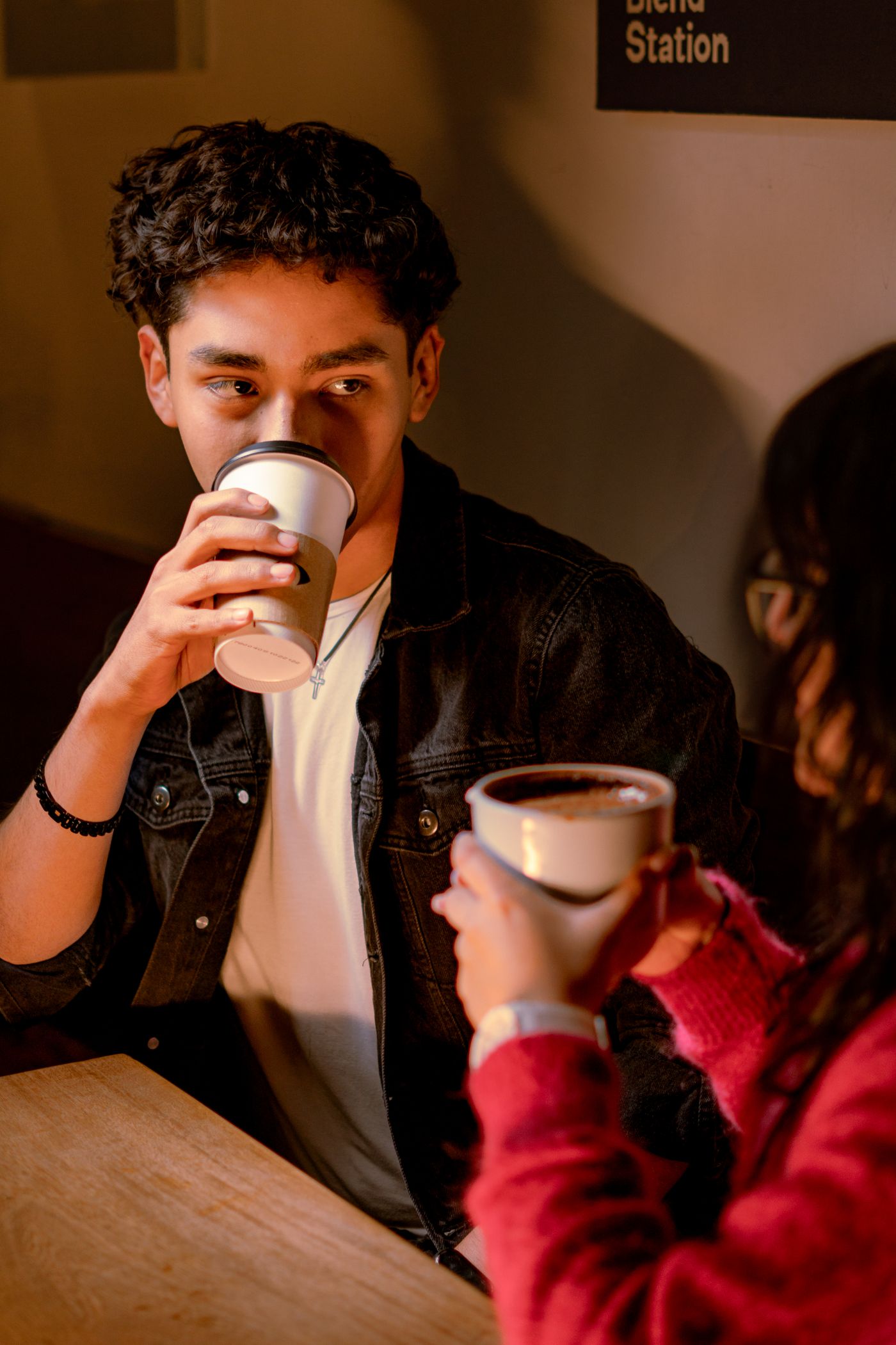 A young couple sharing coffee in a cafe in Mexico City.