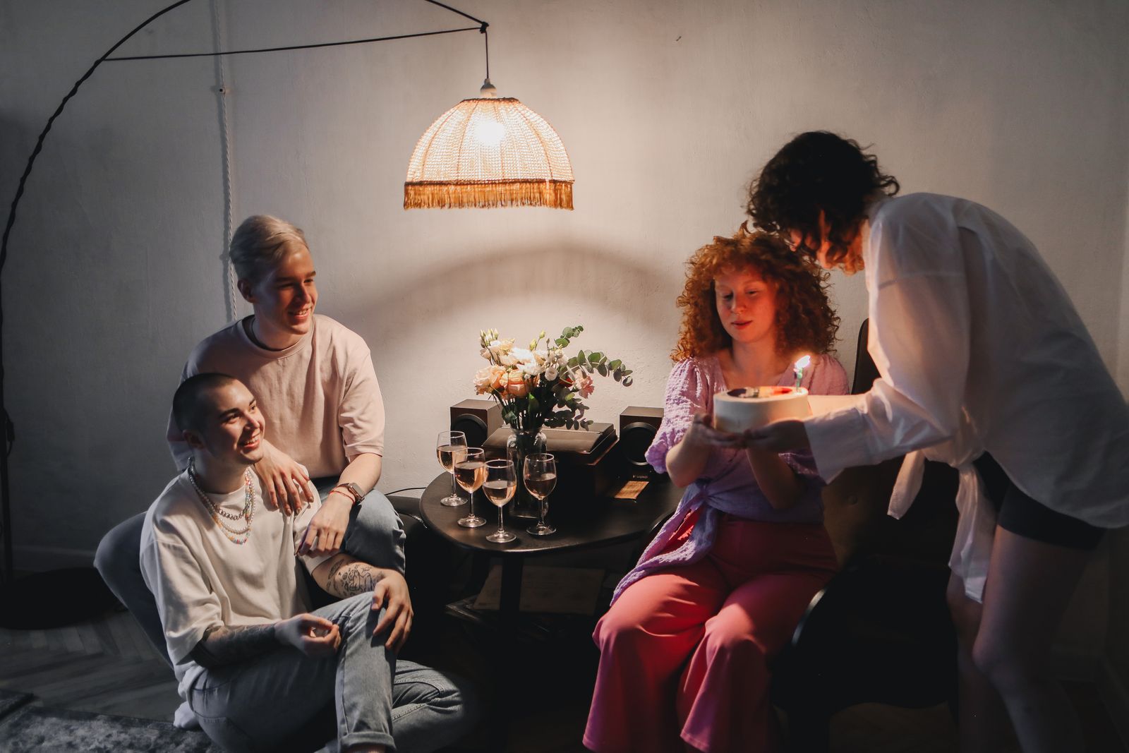 A small group of friends talking at a cozy home celebration.