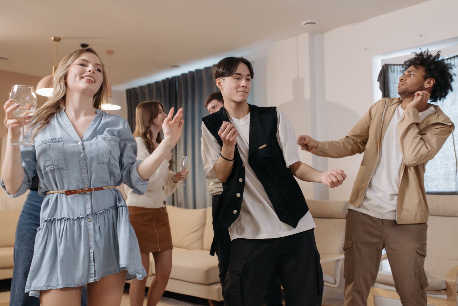 A lively group of friends dancing together at an indoor party.