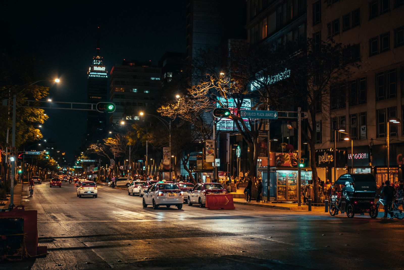 A busy Mexico City street scene at night.