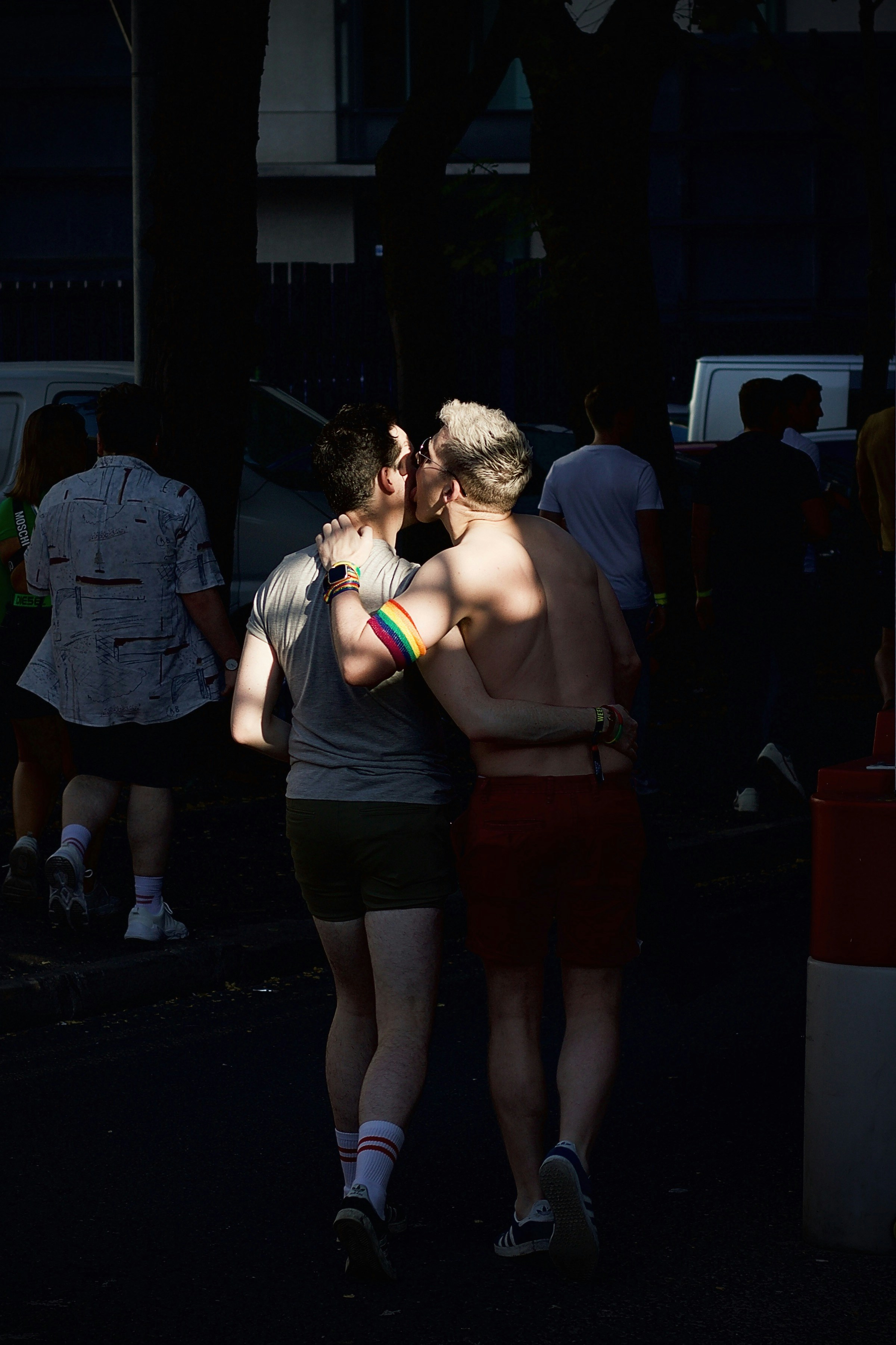 Two people in green outfits celebrating at a Pride street party.