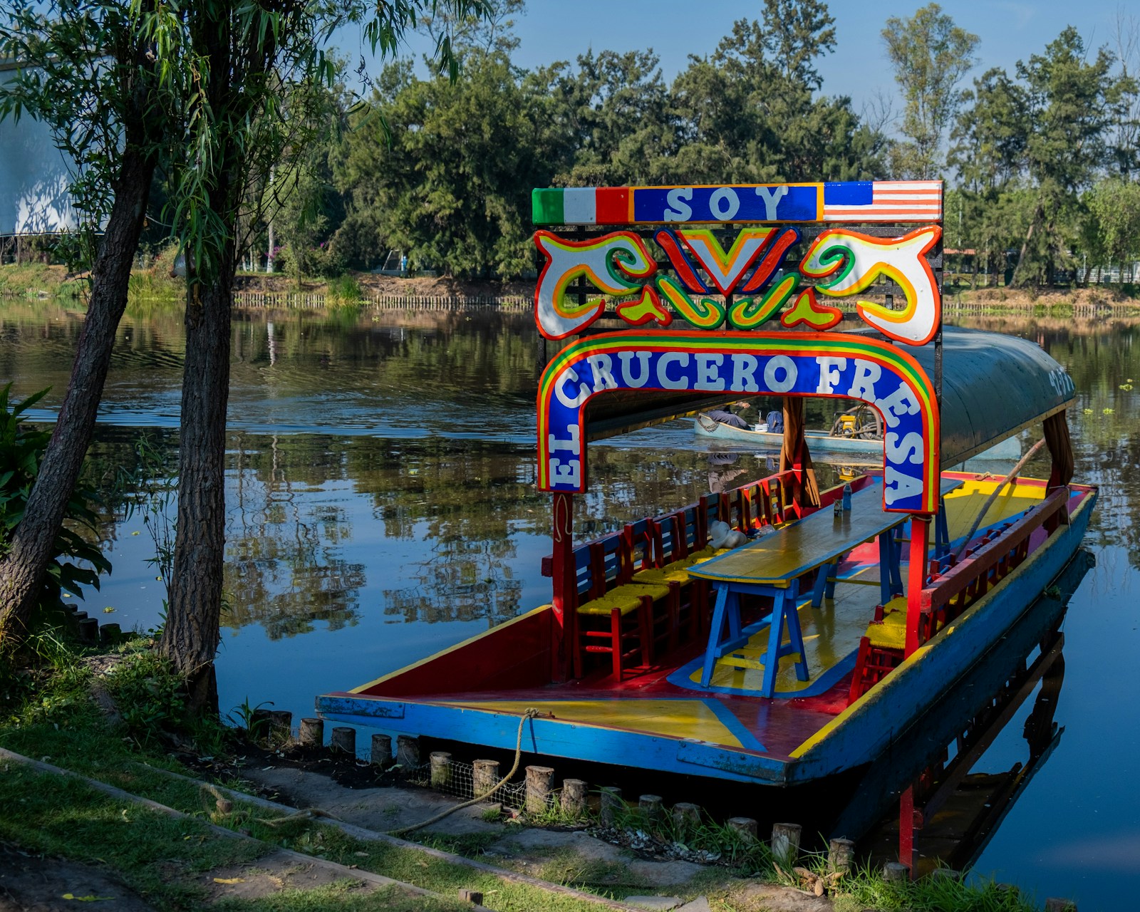 A brightly painted trajinera on the water at Xochimilco.